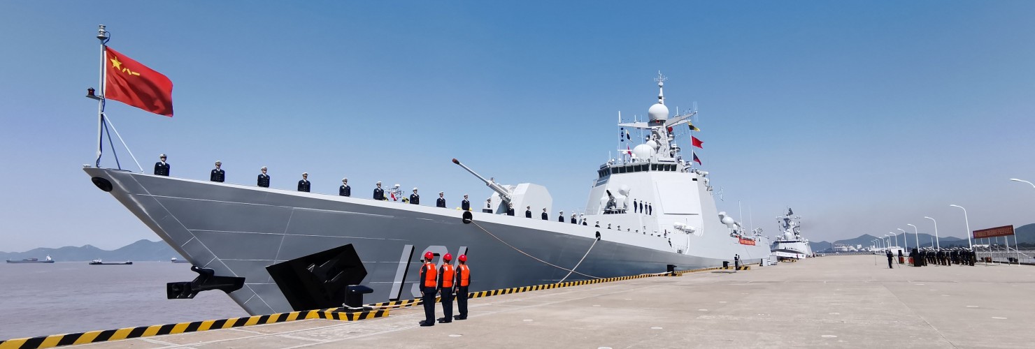 Officers and soldiers of the Chinese naval fleet for escort mission line up on the deck at a port.