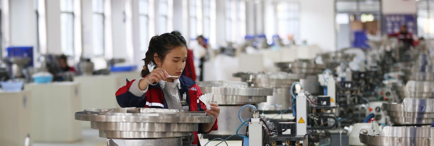 A worker assembles a badminton ball in a production base in Jinping County, Guizhou Province. 