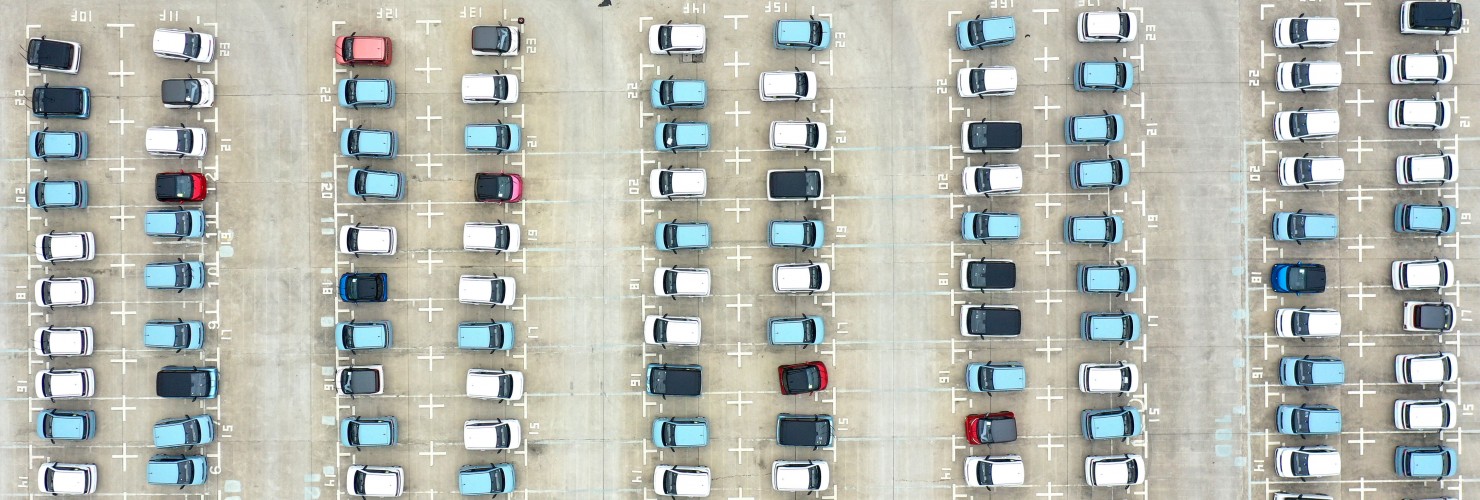 energy vehicles out of a parking lot at a logistics park in Liuzhou