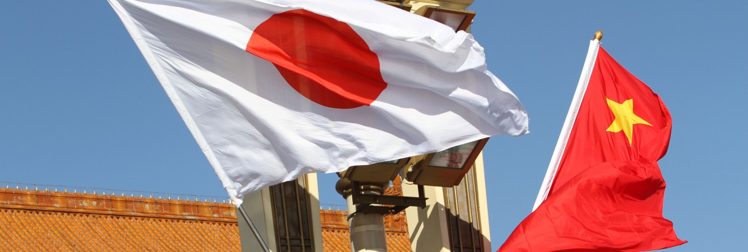 Chinese and Japanese national flags flutter on the lamppost in front of the Tian'anmen Rostrum 