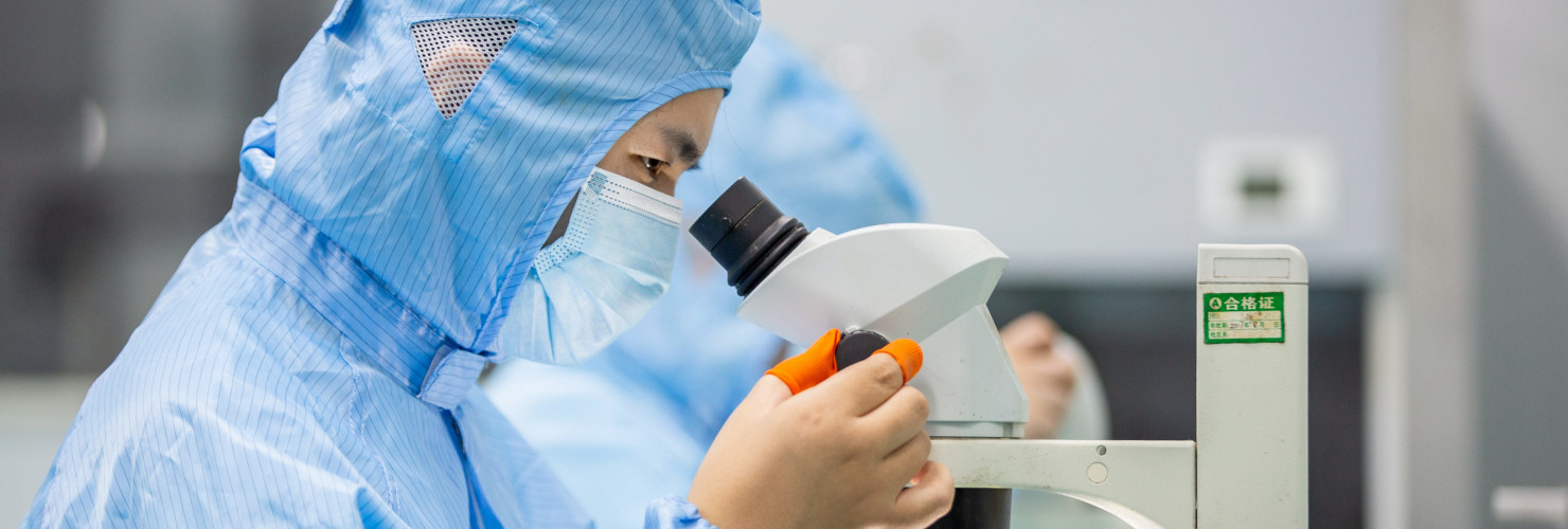 A worker prepares an order for export light filters at a workshop in Nantong, Jiangsu province, China.