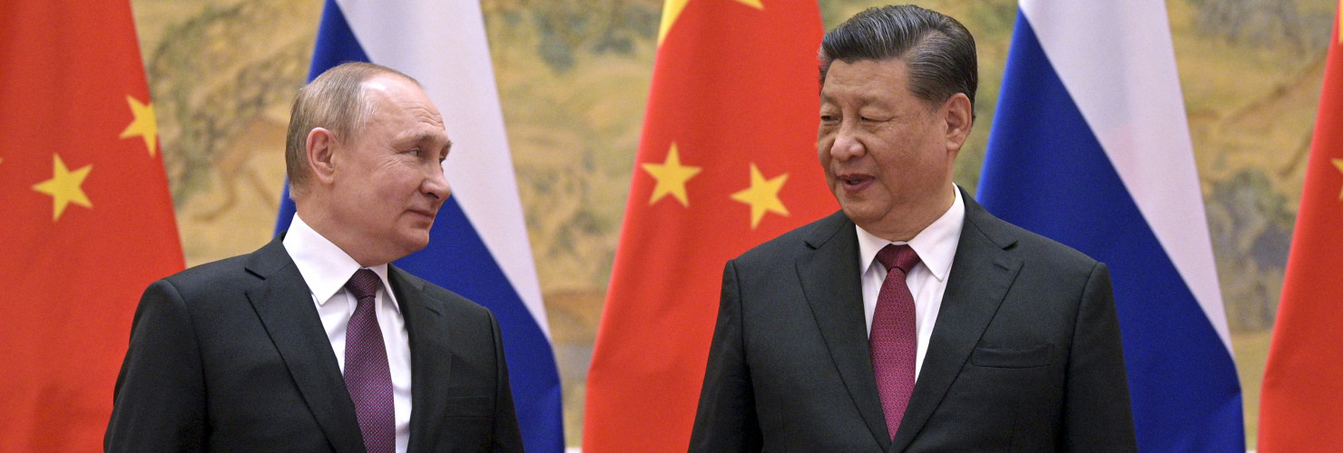 Chinese President Xi Jinping, right, and Russian President Vladimir Putin talk to each other during their meeting in Beijing, China, Friday, Feb. 4, 2022. 