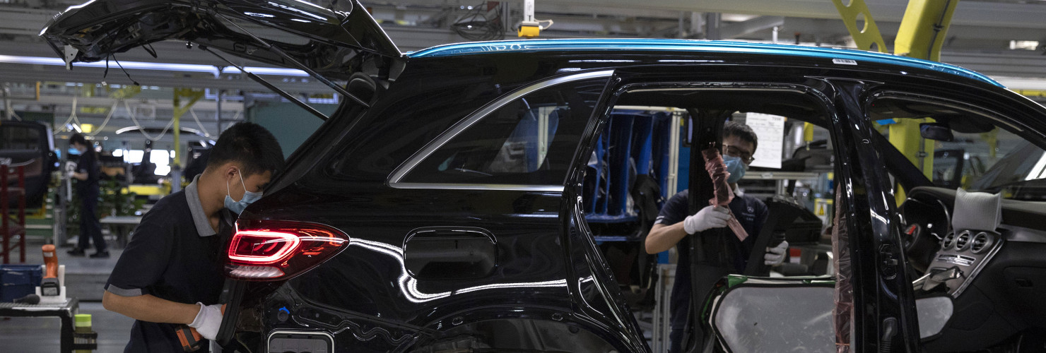 Workers assemble cars at a Beijing Benz Automotive Co. Ltd factory, a German joint venture company for Mercedes-Benz, in Beijing.