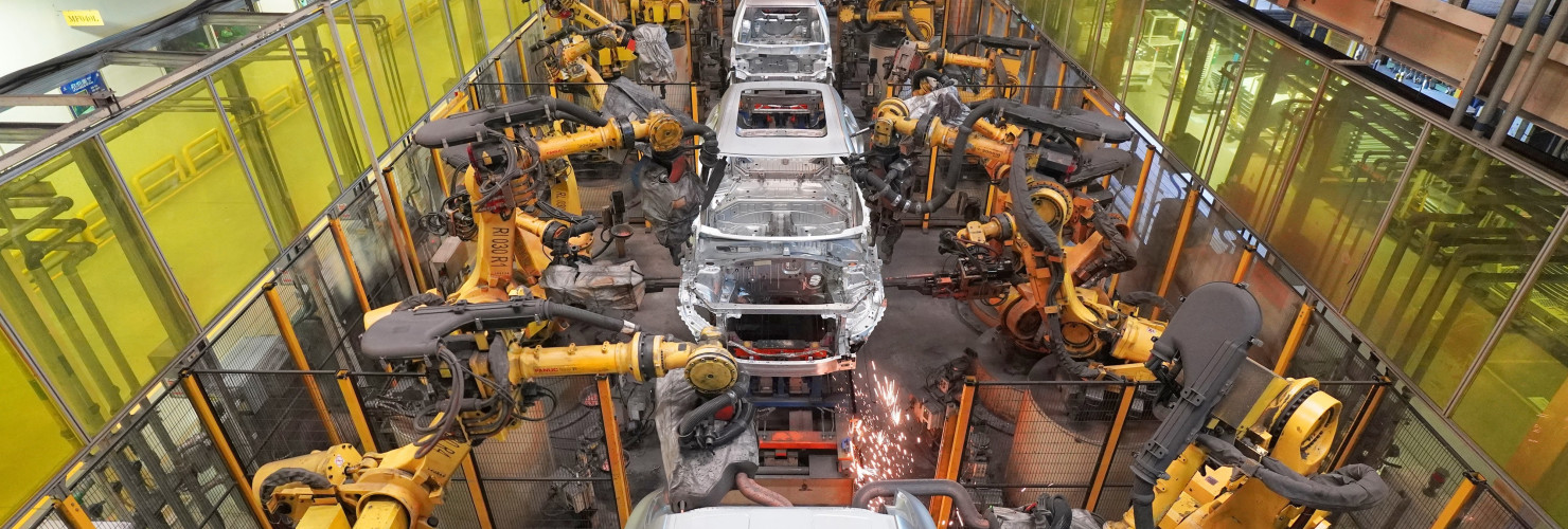 Robots work on a vehicle assembly line in east China's Shandong province