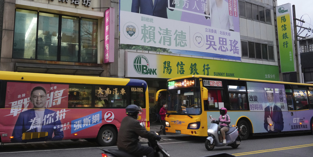 Candidates' posters of the Taiwanese presidential election are hung on a building wall in Taipei on Dec. 21, 2023.