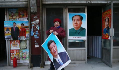 Portraits of Mao and Xi on posters