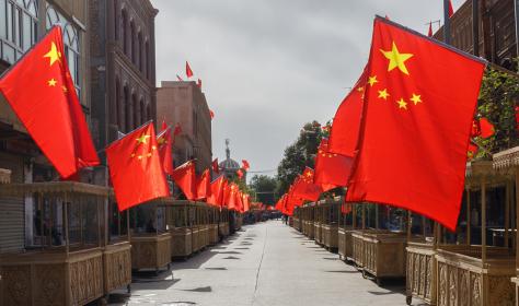 An empty street in Xinjiang with Chinese flags