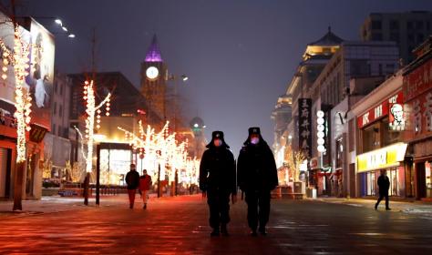 Security guards walking down Wangfujing street in Beijing.