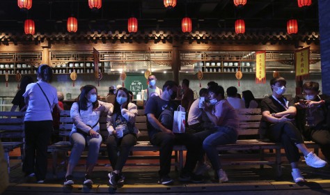 People, most with masks, enjoy visiting an event featuring old streets and atmosphere in Beijing, China.