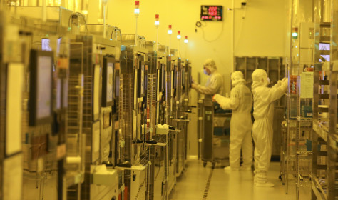 Workers process chips at a workshop of an optoelectronic technology company in Huai 'an city, Jiangsu province, May 11, 2024.