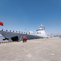 Officers and soldiers of the Chinese naval fleet for escort mission line up on the deck at a port.