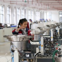 A worker assembles a badminton ball in a production base in Jinping County, Guizhou Province. 