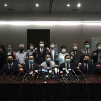 Hong Kong's pro-democracy legislators pose for a photo before a press conference at the Legislative Council in Hong Kong, Wednesday, Nov. 11, 2020.