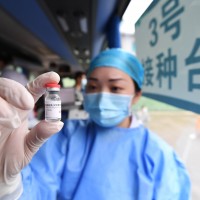 A medical worker shows the COVID-19 vaccine