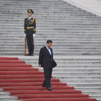 Xi Jinping walks down steps at the Great Hall of the People