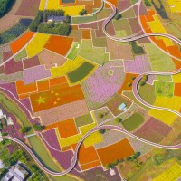 An aerial photo taken on September 29, 2021 shows a five-star red flag composed of autumn flowers in a patch of Flowers in Santaishan Forest Park in Suqian City, Jiangsu Province, China.