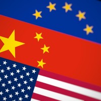 Blurred USA, China and EU flags together on black background