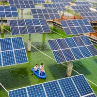 Aerial view of the fishermen working at a fishing area where photovoltaic power panels are used to generate power in Wuzhou city, south China's Guangxi Zhuang autonomous region