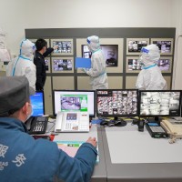 Police, epidemic prevention and control personnel and property management personnel conduct a mobile survey in a containment community during a drill on COVID-19 prevention and control in Yantai High-tech Zone, East China's Shandong Province, January 27, 2022