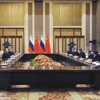 Chinese President Xi Jinping, fourth right, and Russian President Vladimir Putin, fourth left, attend talks in Beijing, China, Friday, Feb. 4, 2022.