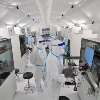 Staff members install and debug equipment at the Huo-Yan laboratory in Yantai, East China's Shandong Province