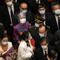 Delegates leave after the closing session of China's National People's Congress (NPC)