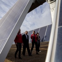 China's Xie Zhenhua, second from left, walks with Chile's Environment Minister Carolina Schmidt, third from left, and Chile's Energy Minister Juan Carlos Jobet, far left, as they tour the Quilapilún solar plant, a joint venture by China and Chile, in Colina, Chile, Tuesday, Aug. 20, 2019.