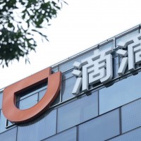 The Didi logo is seen at the top of its headquarters building in Beijing.