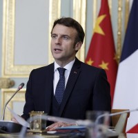 French President Emmanuel Macron attends a video-conference with German Chancellor Olaf Scholz and Chinese President Xi Jinping to discuss the Ukraine crisis at the Elysee Palace in Paris, Tuesday, March 8, 2022. 