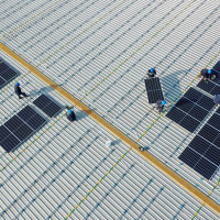 Aerial view of workers installing solar panels on the roof of a plant of China Communications Construction Company (CCCC) Third Harbor Engineering in Zhoushan, Zhejiang Province of China. 