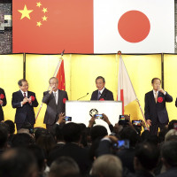 On the stage from left, the Chinese ambassador to Japan Kong Xuanyou, Chairman of the Japan Business Federation Masakazu Tokura, former Japan's Prime Minister Yasuo Fukuda, Head of the Japanese Association for the Promotion of International Trade Yohei Kono, Japan's ruling Liberal Democratic party's politician Toshihiro Nikai and Japanese Foreign Minister Yoshimasa Hayashi toast during a reception to mark the 50th anniversary of Japan-China diplomatic relations Thursday, Sept. 29, 2022, in Tokyo.