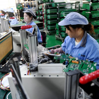 Workers work on a module testing production line in Hebei province, China