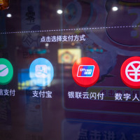 Residents buy drinks at a vending machine by scanning the code of a digital RMB wallet. at Nanjing East Road subway station in Shanghai, China, Feb. 24, 2021.