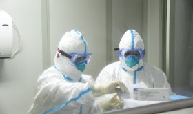  Cao Ting (L) and her colleague prepare to work in the laboratory of Xiaogan's center for disease control and prevention in central China's Hubei Province.