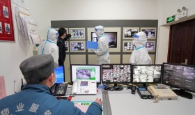 Police, epidemic prevention and control personnel and property management personnel conduct a mobile survey in a containment community during a drill on COVID-19 prevention and control in Yantai High-tech Zone, East China's Shandong Province, January 27, 2022