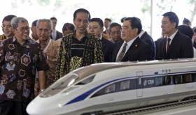 Indonesian President Joko Widodo, center, inspects a model of the high-speed train which will connect the capital city of Jakarta to the country's fourth largest city, Bandung, along with from left to right, West Java Governor Ahmad Heryawan, Director of Indonesia China High Speed Train Hanggoro Budi Wiryawan, President of China Railway Corp.