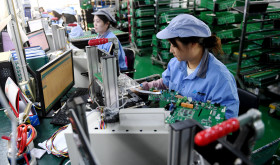 Workers work on a module testing production line in Hebei province, China